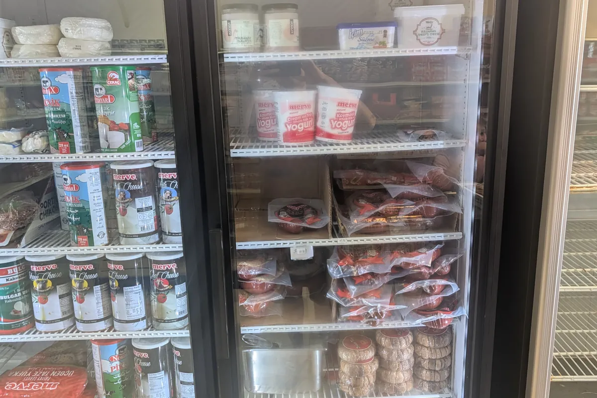 Chilled case of halal sujuk, pastirma and Turkish cheeses at Yener Turkish Food Market