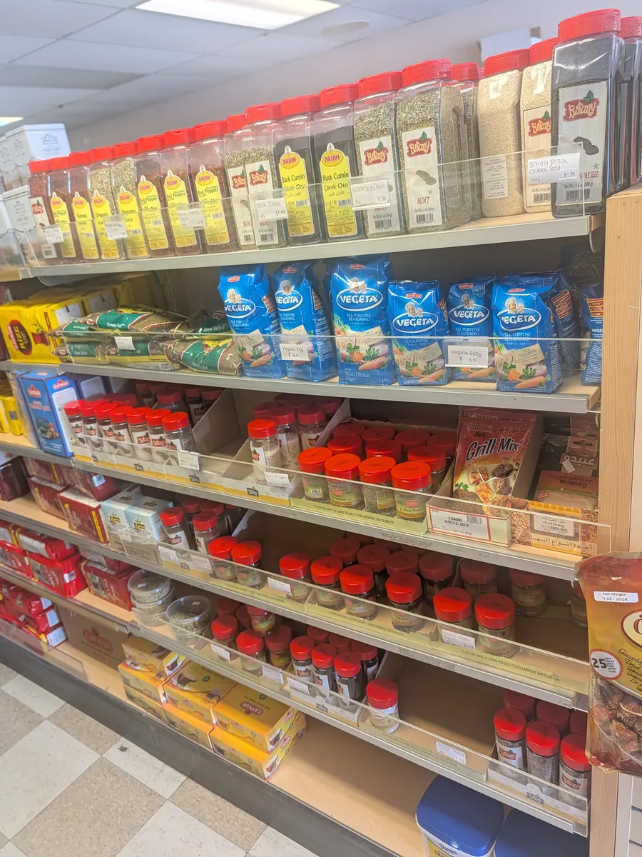 Shelves of imported Turkish olive oils, spices and pantry staples at Yener Turkish Food Market
